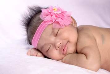 sleeping newborn baby on a blanket