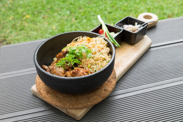Fried pork with garlic vegetable with sauce spicy and sour thai food delicious in black plate on wooden tray
