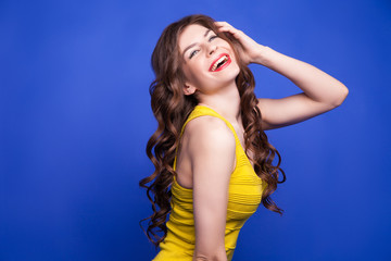 Cheerful model in yellow dress smiling