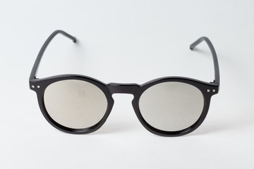 colored summer sunglasses on a white background