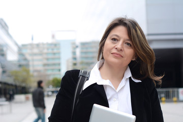 Portrait of business woman holding a tablet.