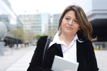 Portrait of business woman holding a tablet.