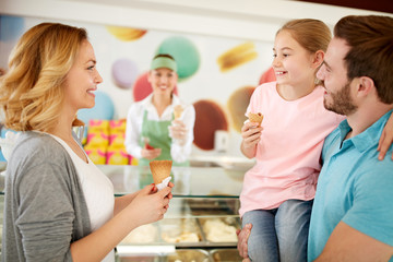 Family eating ice cream in bakery