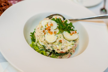 Salad with quail eggs, greens and red caviar