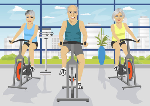 Senior people working out at fitness center on exercise bikes
