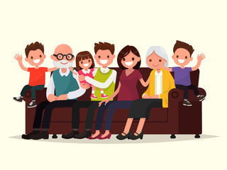 Obraz premium Big family sitting on the sofa. Grandfather, grandmother, father