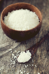 grated coconut on wooden surface