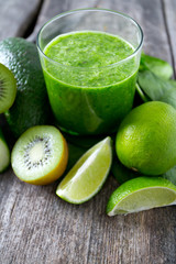 fresh green smoothie on wooden surface
