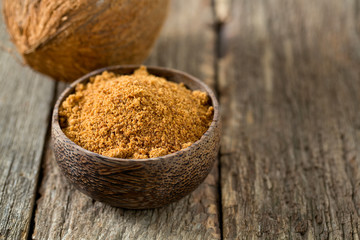 coconut palm sugar on wooden surface