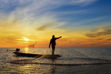 Throwing fishing net during sunrise, Thailand