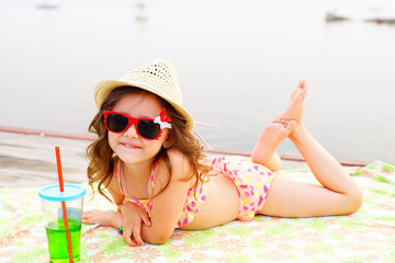 Little girl sunning at the pier