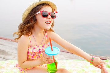 little girl resting on the pier