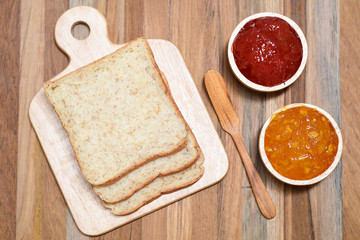 slices bread with jam on wooden table