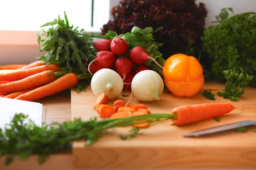 Young woman cutting vegetables in the kitchen