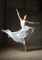 Beautiful ballet dancer in white costume with waving skirt dancing