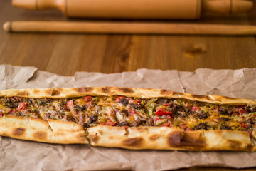 Turkish pide with cheese and cubed meat / kusbasili kasarli pide