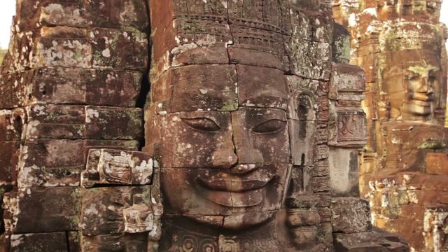 Video 1080p - Ancient giant faces sculpted from stone at Bayon Temple in Cambodia