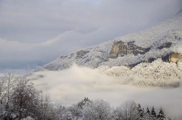 Fototapeta na wymiar Montagne sous la neige et nuages