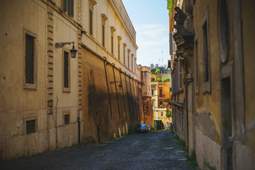 Obraz premium Old cobbled streets of Rome. Tourists and visitors stroll through the narrow the town.
