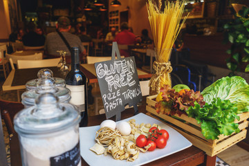 Decoration on the table the necessary ingredients for making traditional Italian pasta with vegetables and herbs.