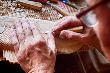 cutter carves the fish from the wood. woodcarving closeup
