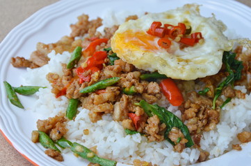 spicy stir fried minced pork with basil leaf topping egg on rice
