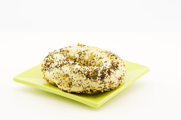 Everything bagel on green plate
