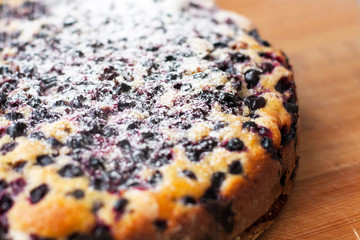 Tasty pie with blueberries on wooden table