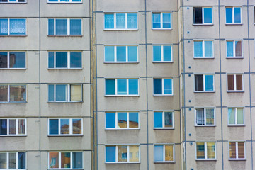 Fototapeta na wymiar Windows mirroring home building in block of flats