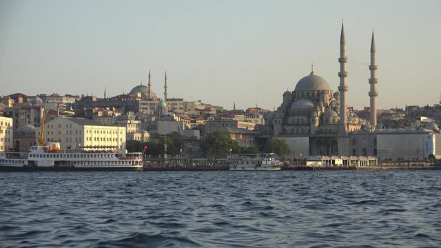 The view of Yeni Cami (New Mosque) originally named the Valide Sultan Mosque (Valide Sultan Camii)  over Golden Horn bay, Istanbul, Turkey
