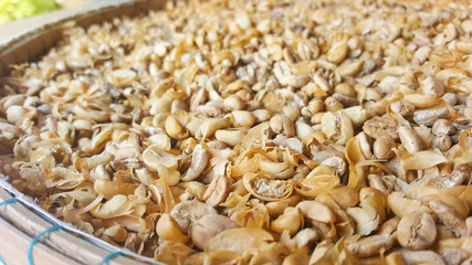 Raw coffee bean with peel with on basket