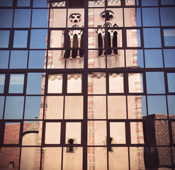 old church mirrored in modern glass facade in Strasbourg - France
