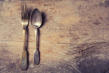 old cutlery on wooden table