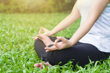 Young woman doing yoga in the park,Close up yoga  relax in nature