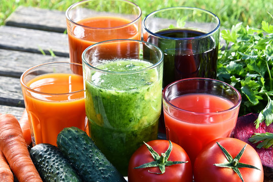 Glasses with fresh organic detox juices in the garden