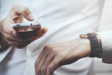 man hand watch and phone