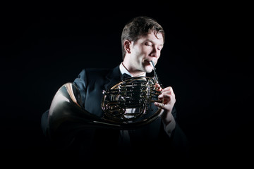 French horn player with instrument