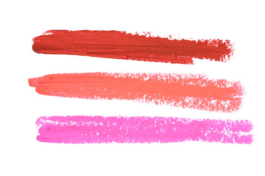 Smudged lipsticks isolated on white background