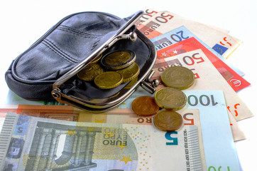 Euros in black purse and coins on a white background.