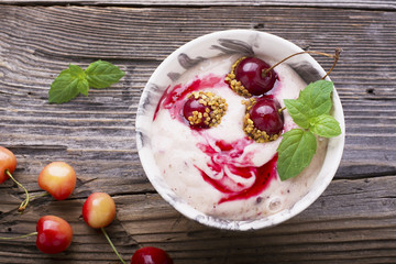 Smoothie bowl topped with cherry, bee pollen