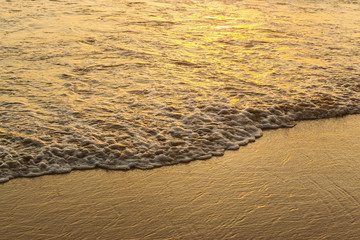 Wave of the sea and sand beach sunset