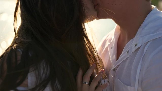 Couple kissing on the sea background.