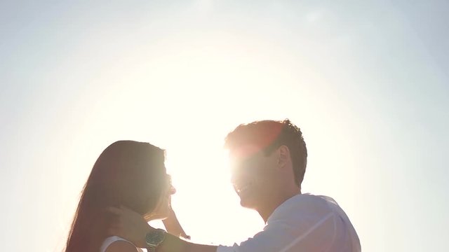 Couple kissing on the blue sky background.