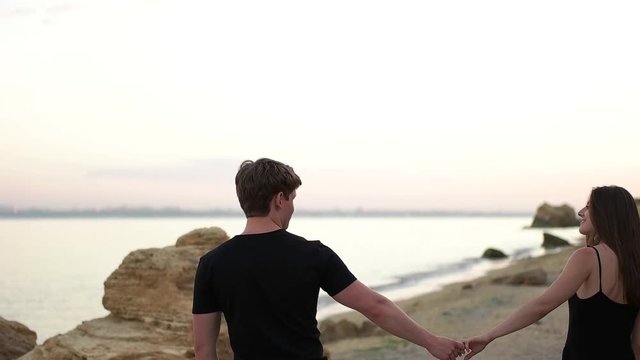 Couple walking on the sand beach.