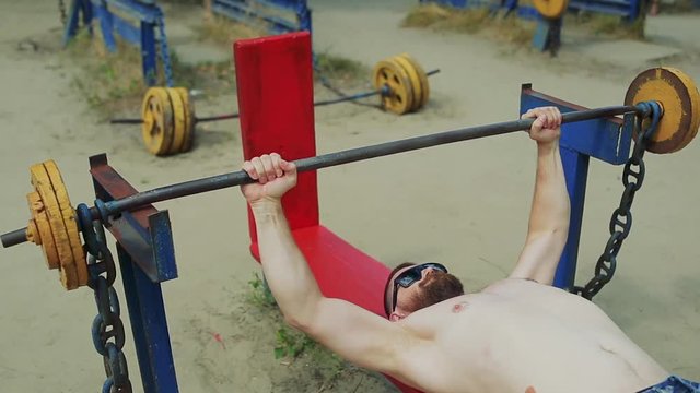 man doing exercise with barbell
