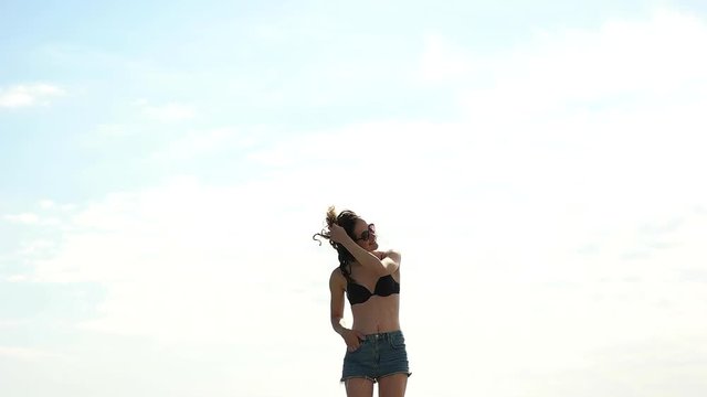 Girl in shorts hair playing.