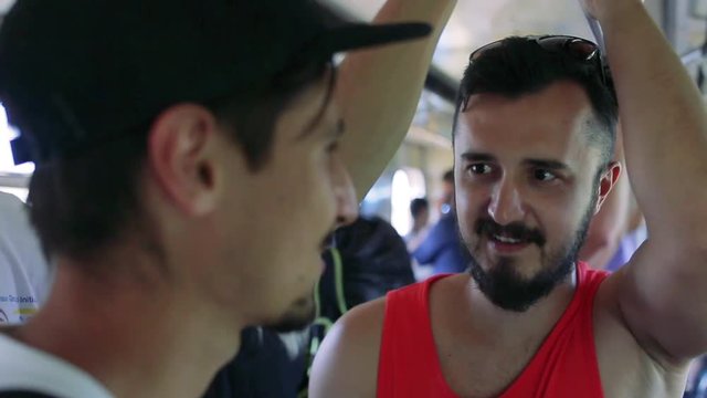 two men riding in the subway