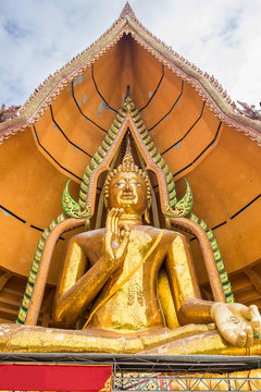 Gold big buddha statue in temple at wat tham sua, kanchanaburi, thailand