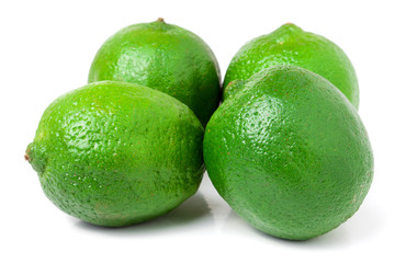 four lime isolated on white background close up