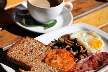 Hearty breakfast with a cappucino on a wooden table